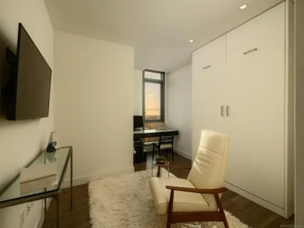 a view of a workspace with furniture and wooden floor