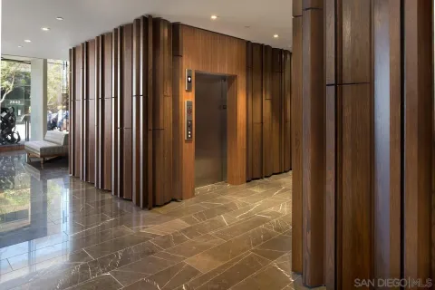 a view of a hallway with wooden staircase