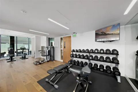 a room with gym equipment and a large window
