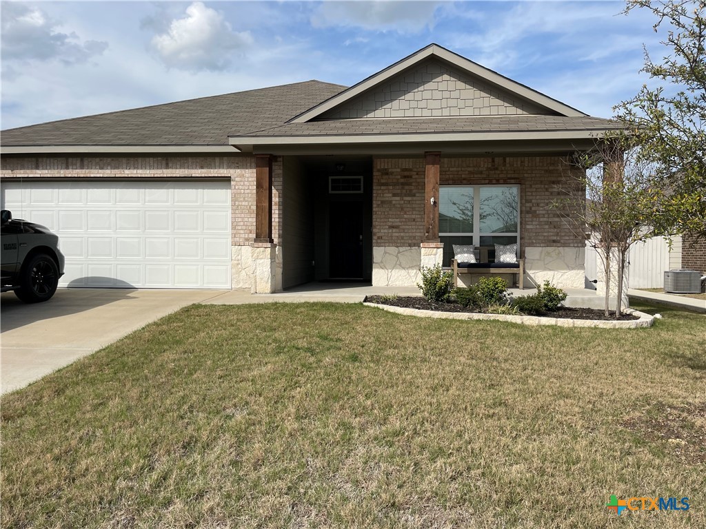 a view of a house with backyard and parking space