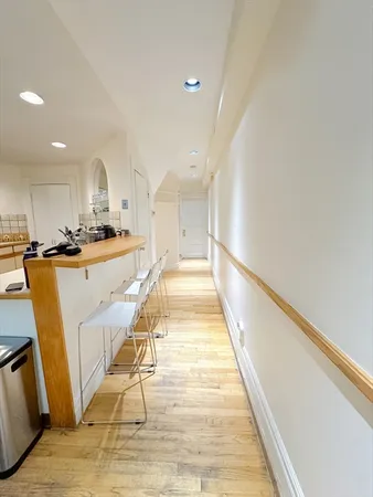 a view of a kitchen with wooden floor and electronic appliances