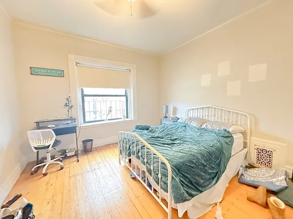 a bedroom with a bed and a window