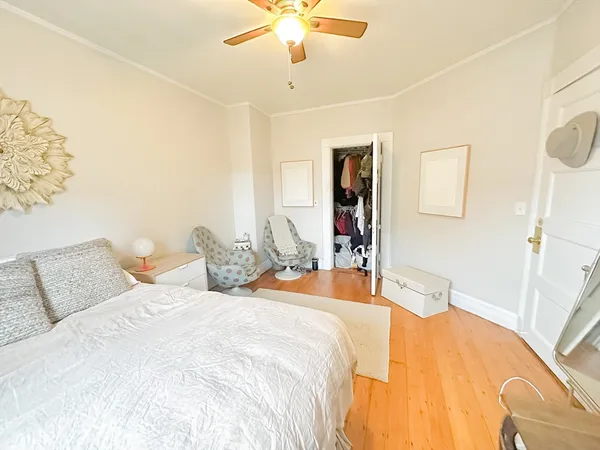 a bedroom with bed and a chandelier
