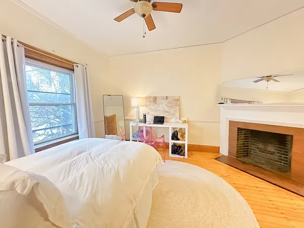 a bedroom with a bed and a fireplace