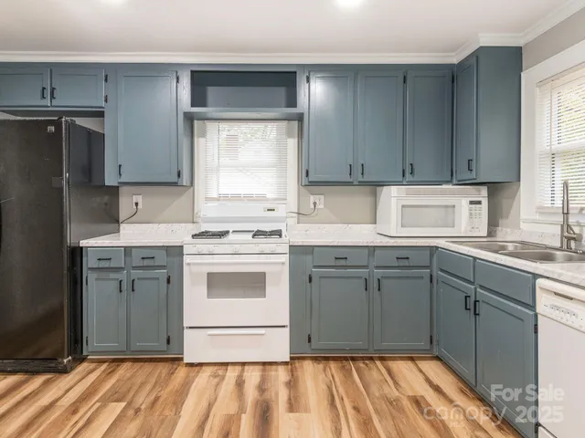 a kitchen with a sink stove and refrigerator