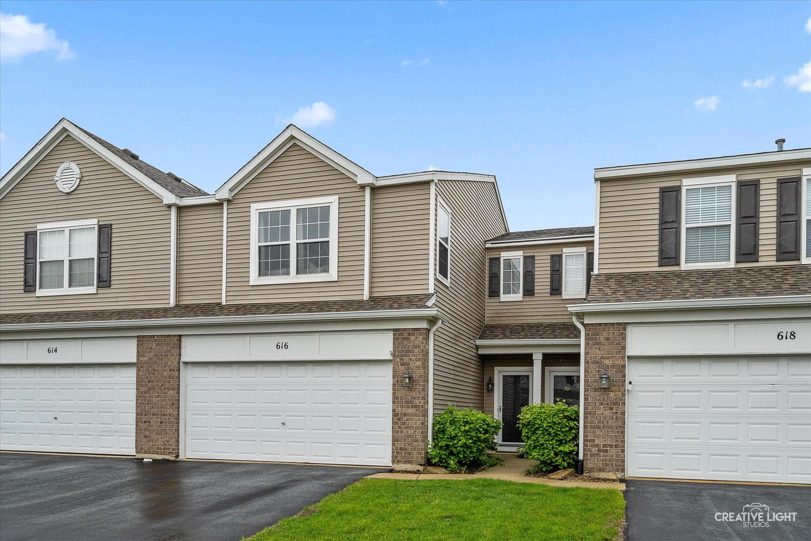 a front view of a house with a yard and garage