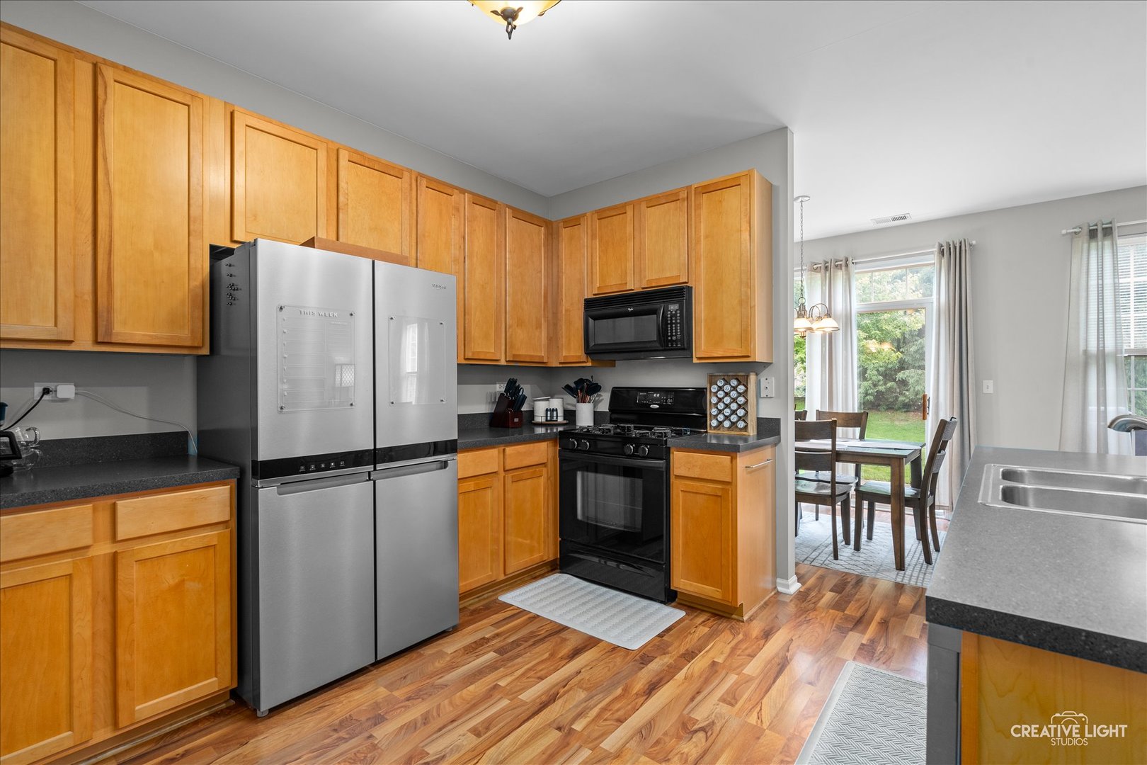 616 Springbrook Trail North Oswego, IL 60543 - Photo 11 of 18 a kitchen with stainless steel appliances granite countertop a refrigerator stove microwave and sink