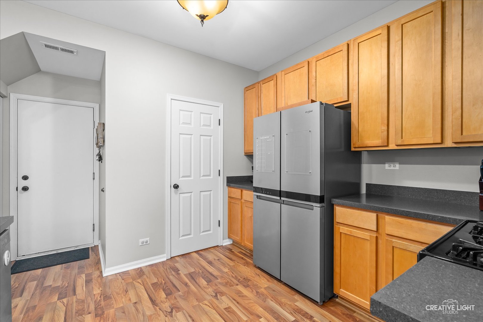 616 Springbrook Trail North Oswego, IL 60543 - Photo 12 of 18 a kitchen with stainless steel appliances granite countertop a refrigerator and a stove top oven
