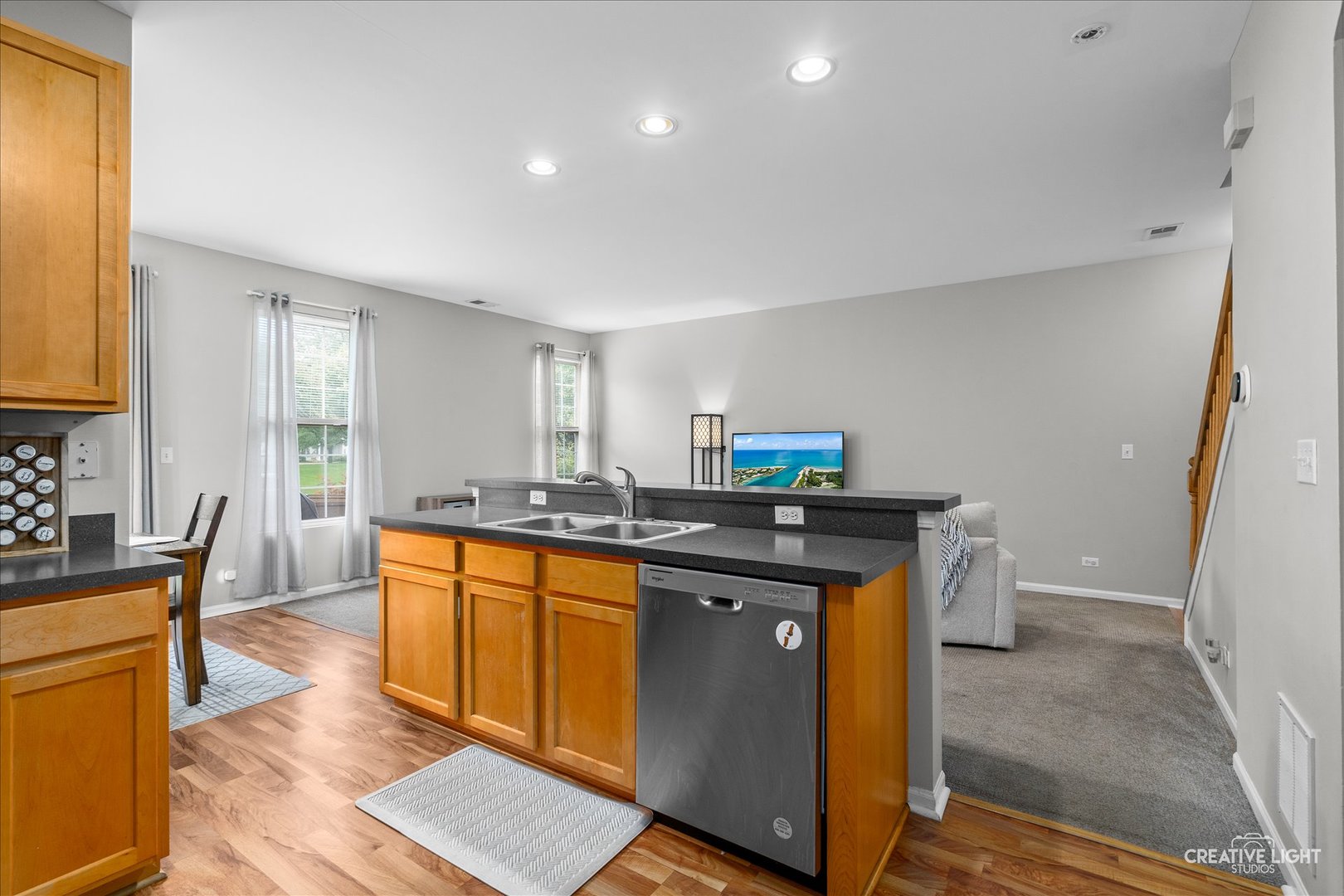616 Springbrook Trail North Oswego, IL 60543 - Photo 13 of 18 a kitchen with stainless steel appliances granite countertop a sink and wooden floors