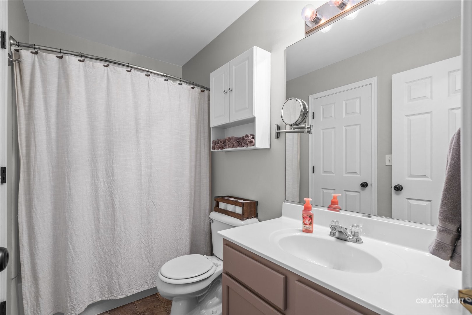 616 Springbrook Trail North Oswego, IL 60543 - Photo 17 of 18 a bathroom with a sink a toilet and shower curtain