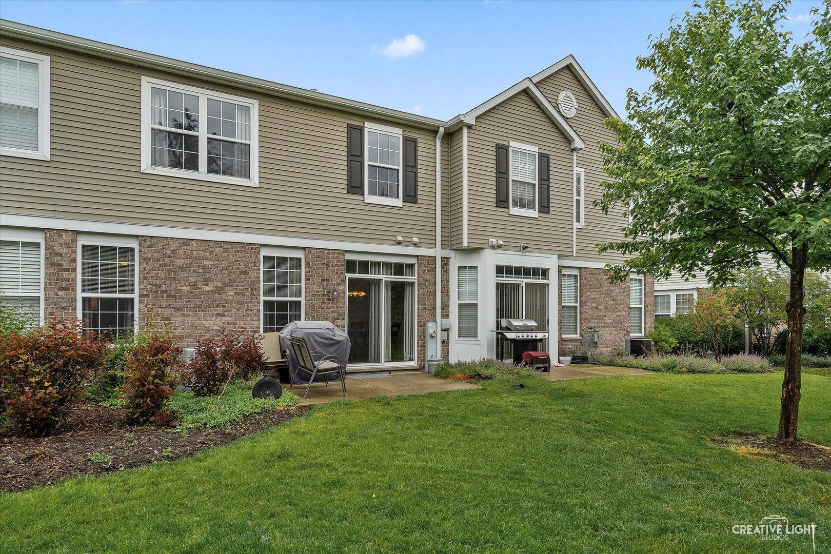 616 Springbrook Trail North Oswego, IL 60543 - Photo 18 of 18 a front view of a house with a garden and yard