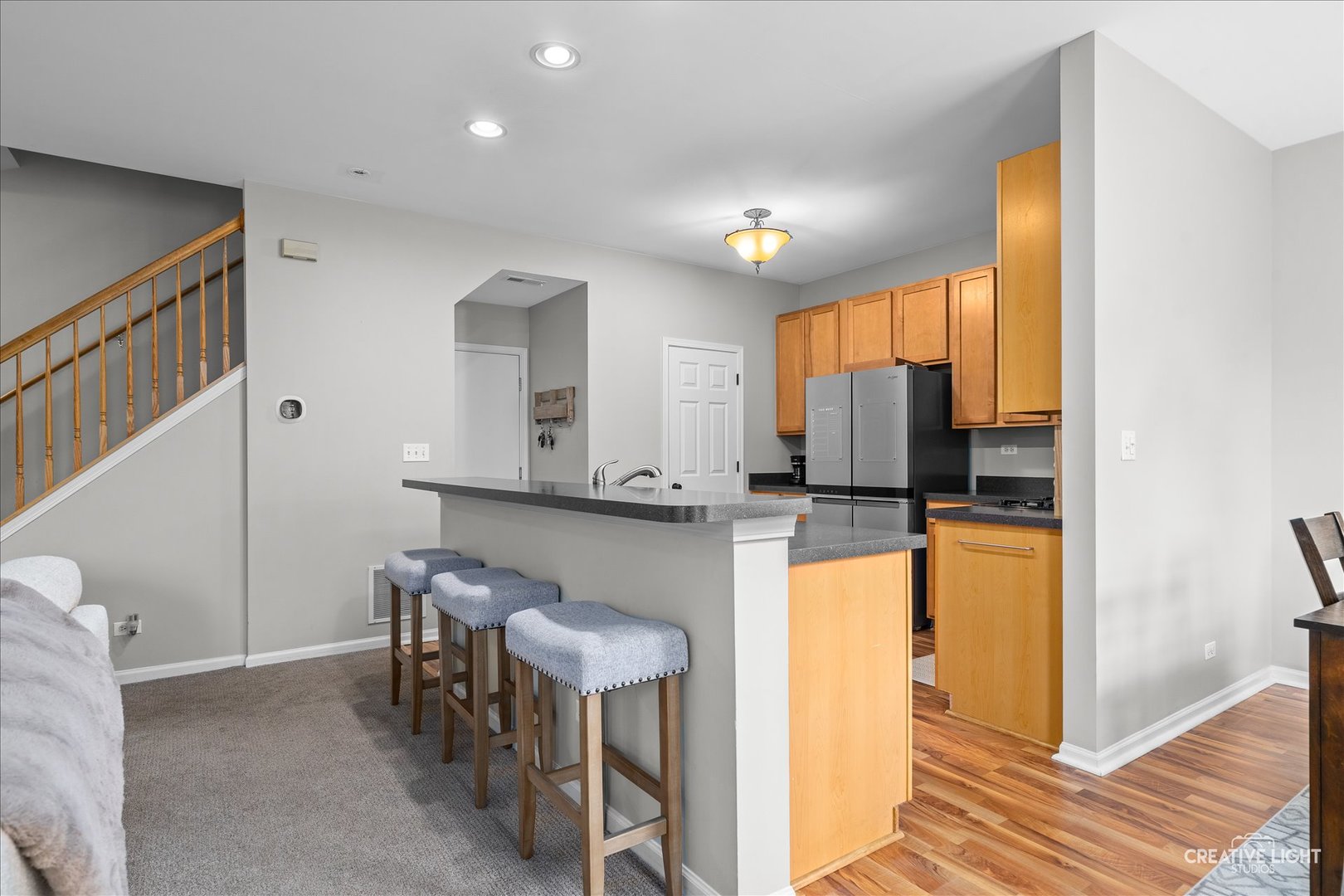616 Springbrook Trail North Oswego, IL 60543 - Photo 10 of 18 a kitchen with table chairs refrigerator and microwave