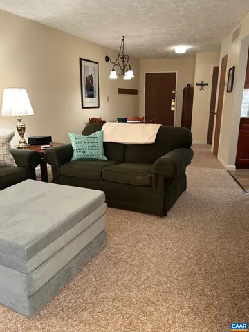 a living room with furniture and a lamp