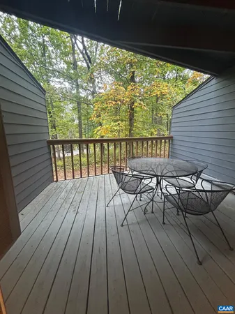 a view of balcony with chairs and wooden floor