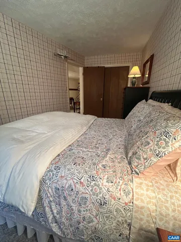 a bedroom with a bed and a closet