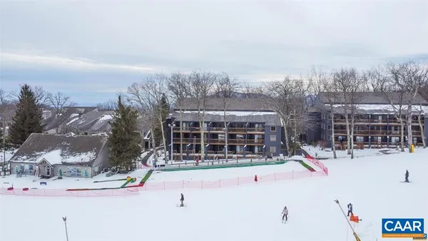 a view of a house with a snow in the background