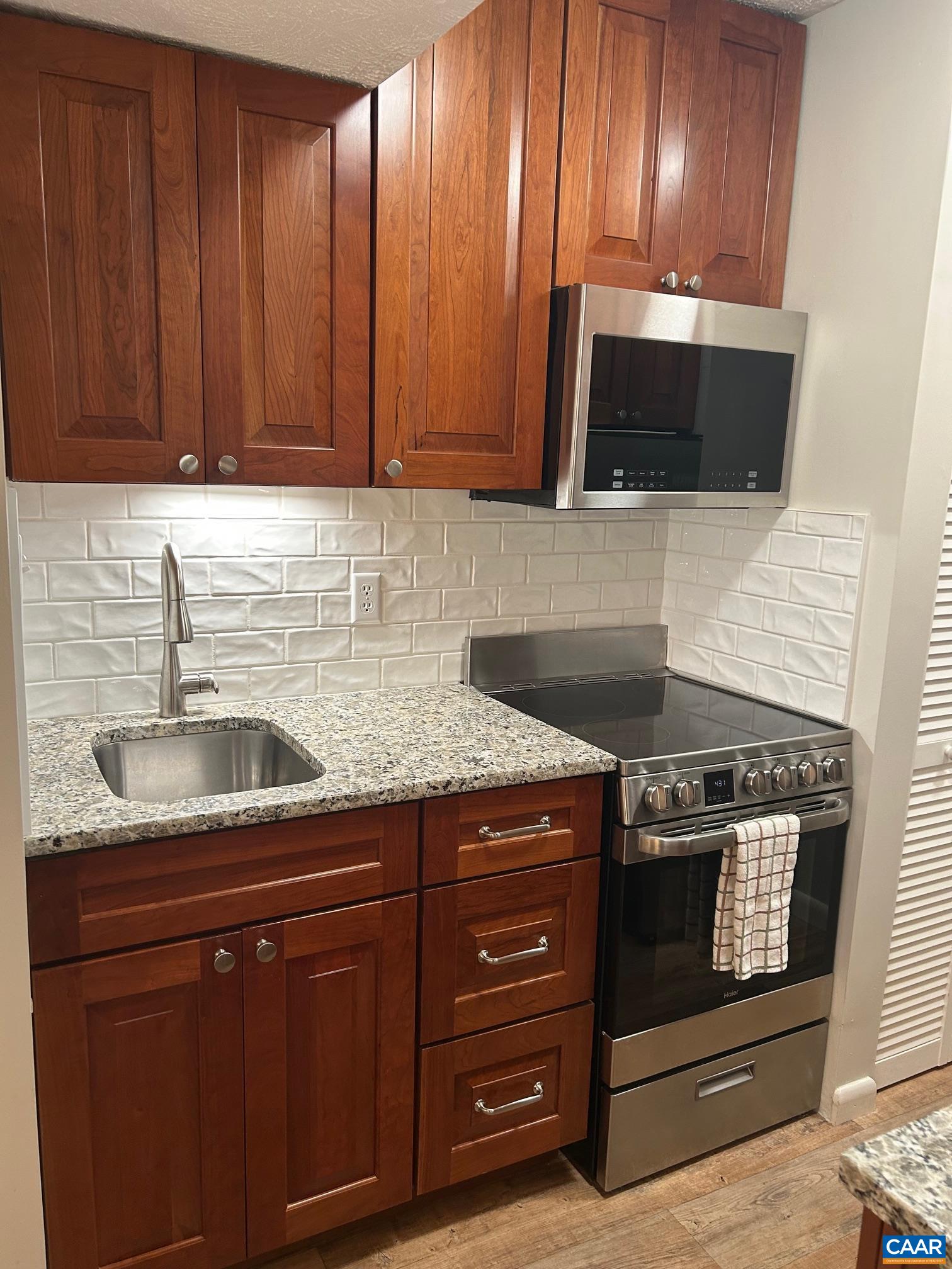 240 Timbers Roseland, VA 22967 - Photo 5 of 22 a kitchen with granite countertop stainless steel appliances wooden cabinets and a sink