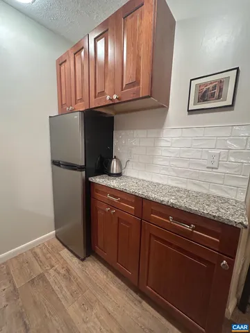 a kitchen with granite countertop cabinets stainless steel appliances and a counter space