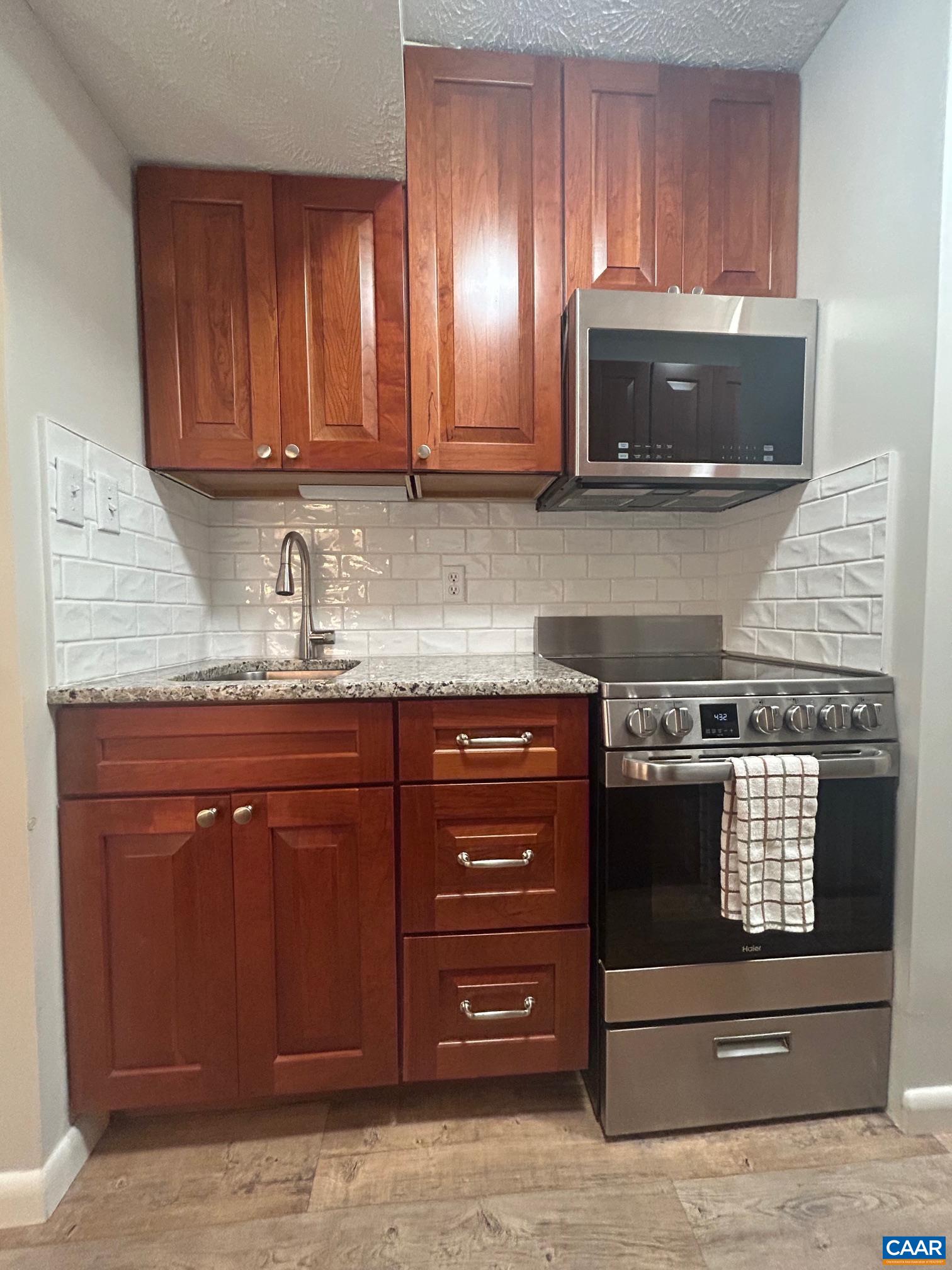 240 Timbers Roseland, VA 22967 - Photo 8 of 22 a kitchen with granite countertop a stove and a microwave oven