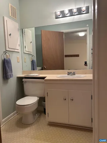 a bathroom with a sink toilet and mirror