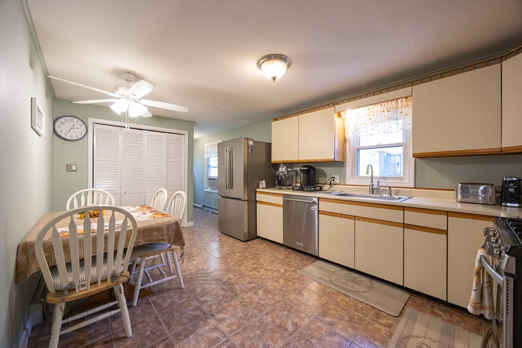 11 Edgeworth Street Billerica, MA 01821 - Photo 13 of 40 a kitchen with a dining table chairs stainless steel appliances and cabinets