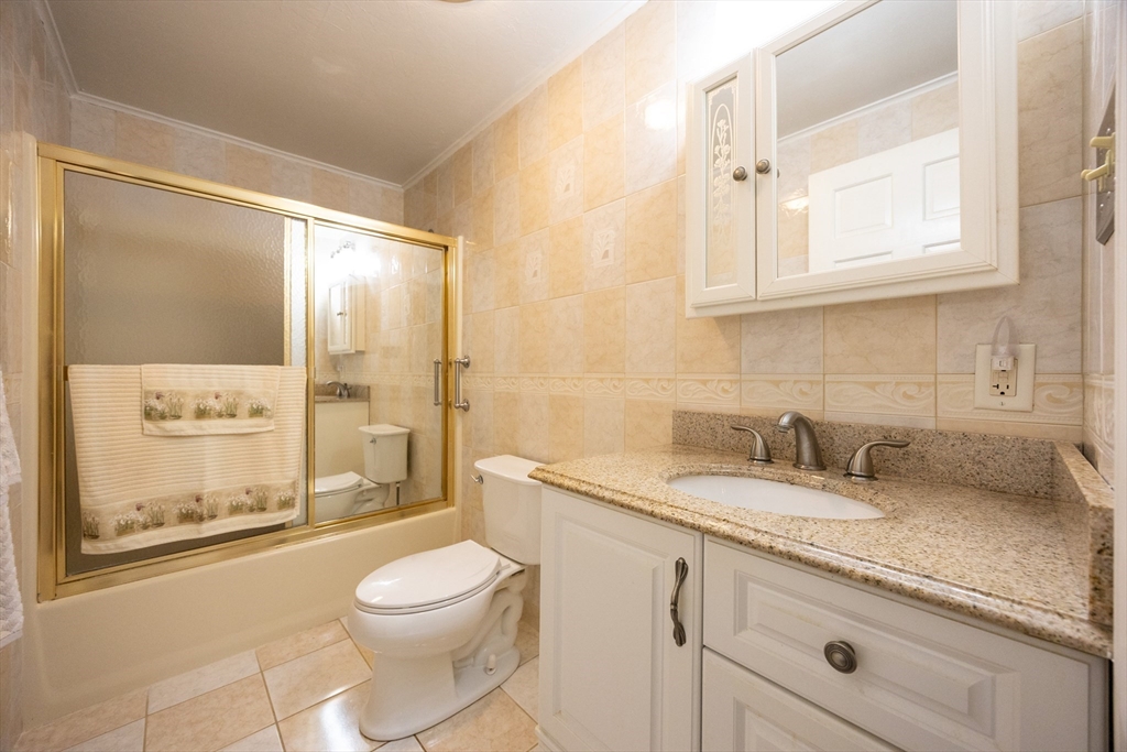 11 Edgeworth Street Billerica, MA 01821 - Photo 21 of 40 a bathroom with a granite countertop sink toilet and shower