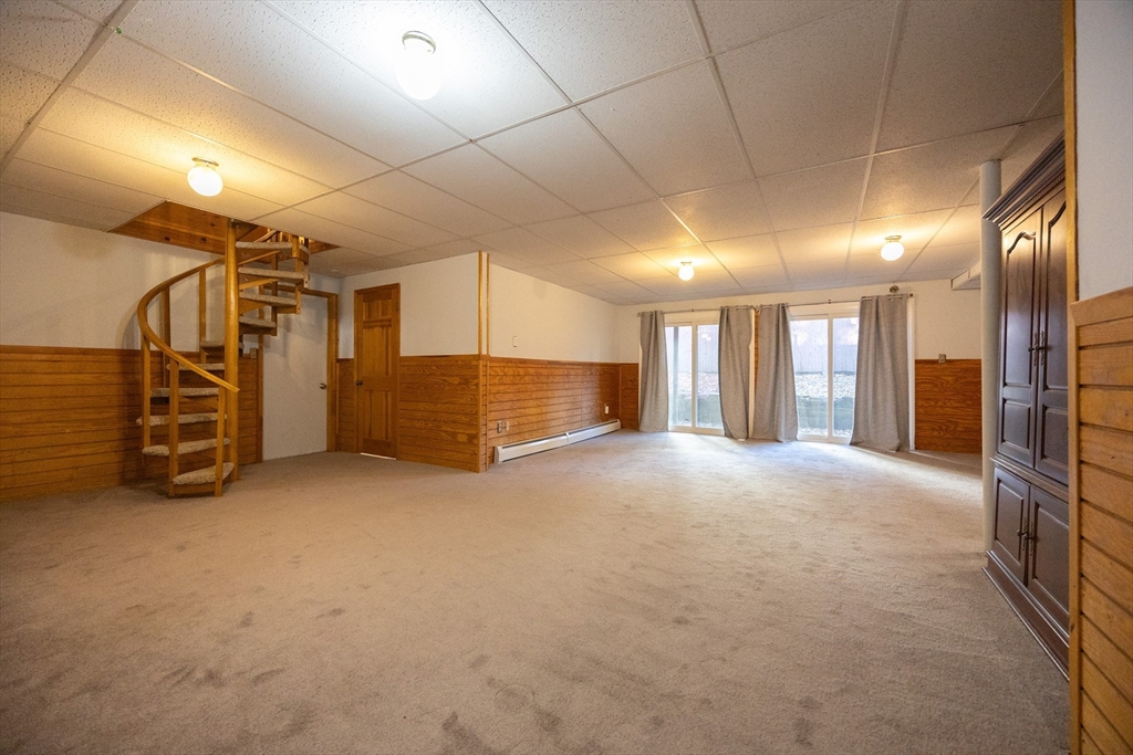 11 Edgeworth Street Billerica, MA 01821 - Photo 23 of 40 a view of water heater room with a garage
