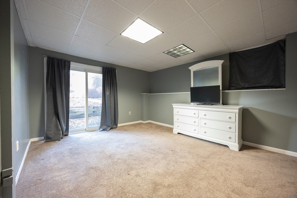 11 Edgeworth Street Billerica, MA 01821 - Photo 29 of 40 a view of an empty room with a window and a kitchen