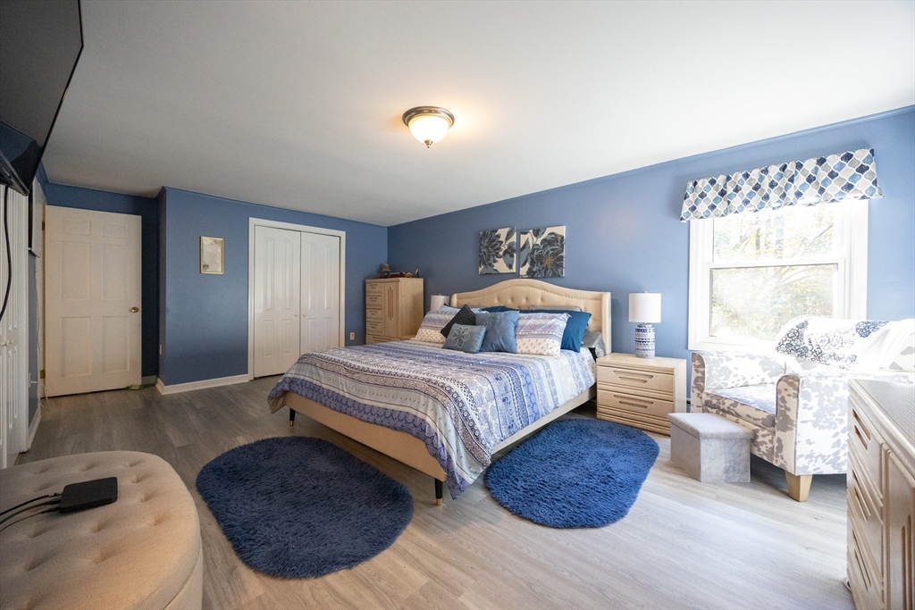 11 Edgeworth Street Billerica, MA 01821 - Photo 3 of 40 a bedroom with a large bed and a potted plant