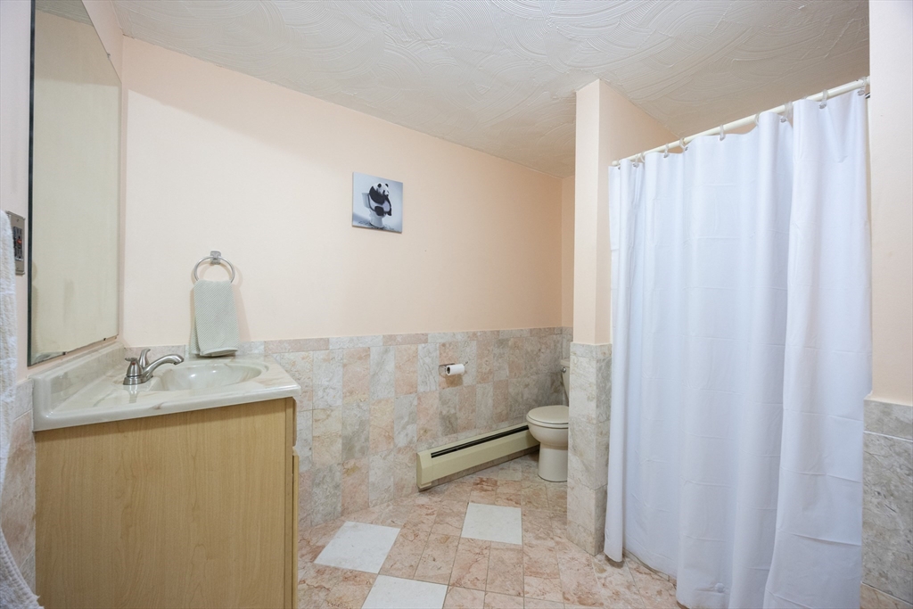 11 Edgeworth Street Billerica, MA 01821 - Photo 31 of 40 a bathroom with a sink and a mirror
