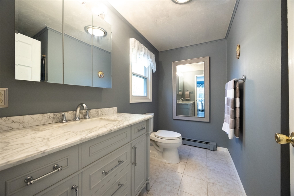 11 Edgeworth Street Billerica, MA 01821 - Photo 5 of 40 a bathroom with a granite countertop sink toilet and mirror