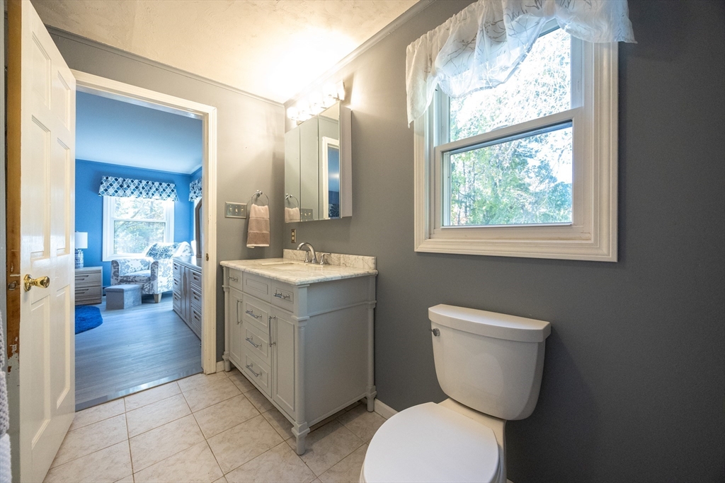 11 Edgeworth Street Billerica, MA 01821 - Photo 6 of 40 a bathroom with a toilet sink and a mirror