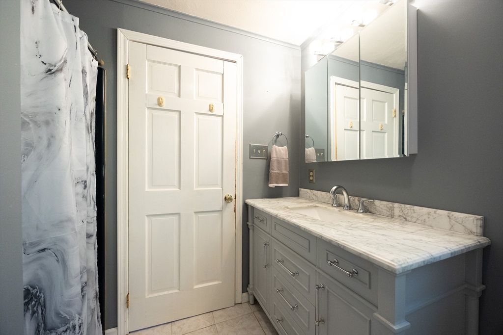 11 Edgeworth Street Billerica, MA 01821 - Photo 7 of 40 a bathroom with a sink vanity and a mirror