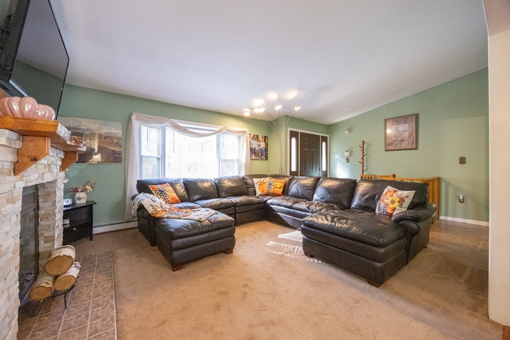 11 Edgeworth Street Billerica, MA 01821 - Photo 8 of 40 a living room with furniture and a fireplace