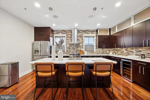 a living room with a fireplace furniture and a large window