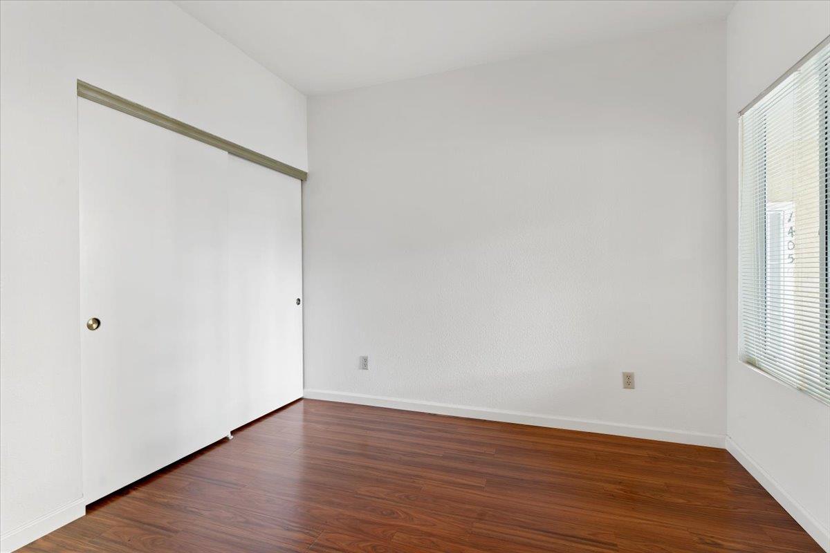 1403 Forest Run Hercules, CA 94547 - Photo 15 of 26 a view of an empty room with wooden floor and a window