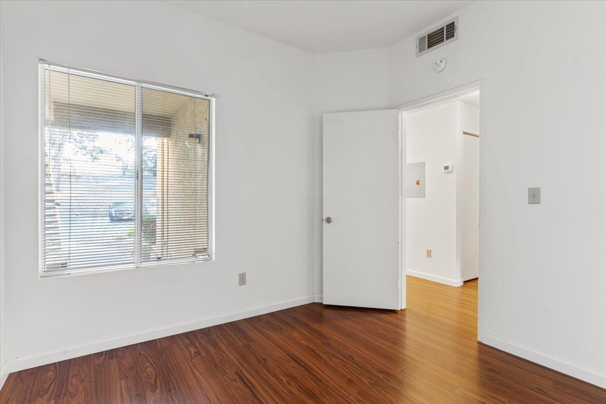 1403 Forest Run Hercules, CA 94547 - Photo 16 of 26 a view of an empty room with wooden floor and a window