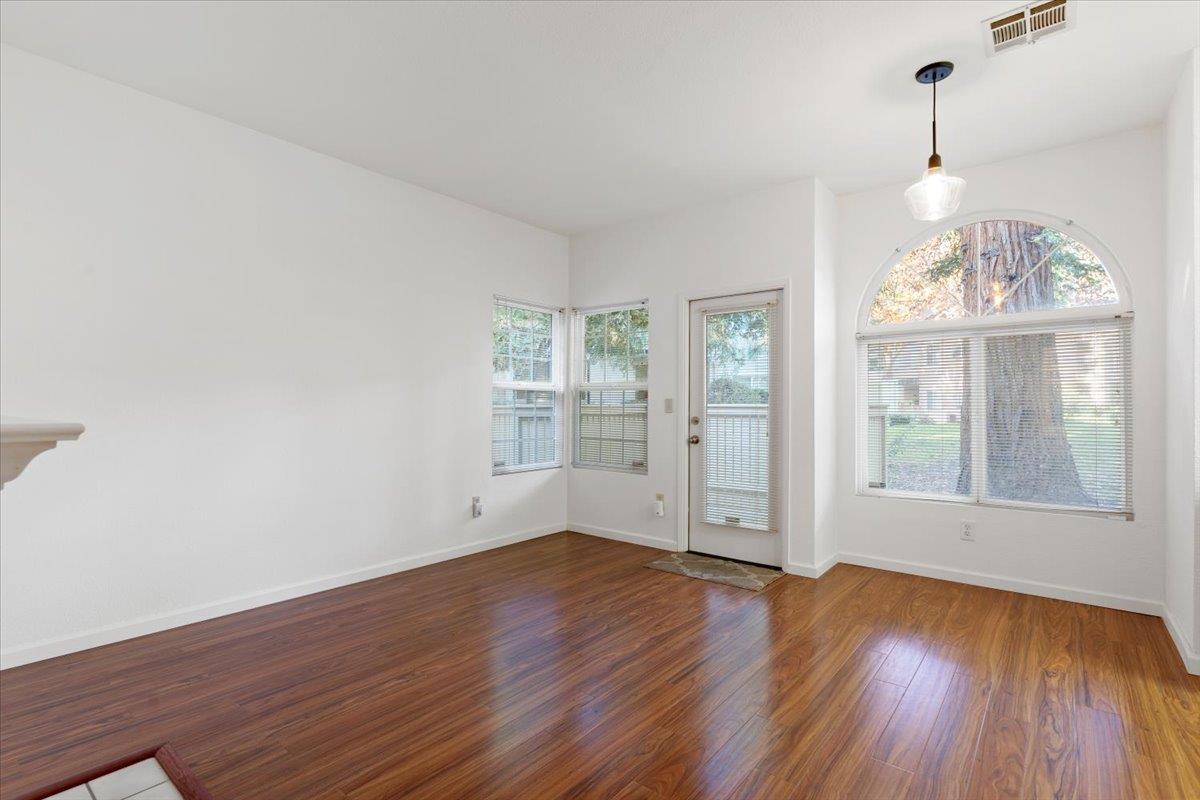 1403 Forest Run Hercules, CA 94547 - Photo 4 of 26 an empty room with wooden floor chandelier and windows