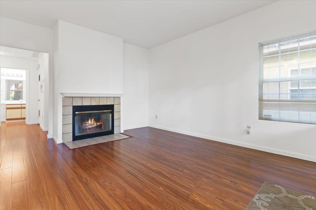 1403 Forest Run Hercules, CA 94547 - Photo 5 of 26 a view of an empty room with wooden floor fireplace and a window