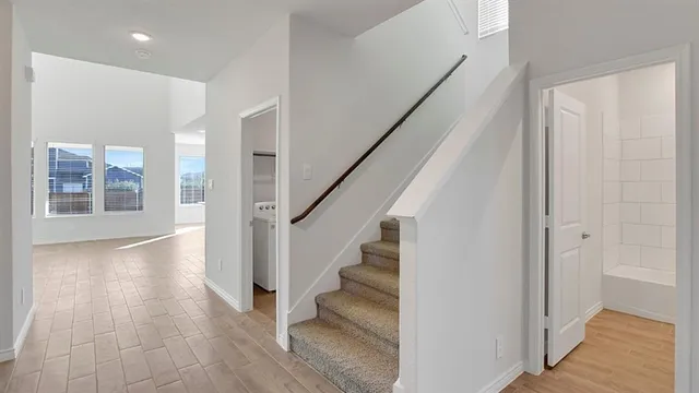 a view of an entryway with wooden floor and staircase