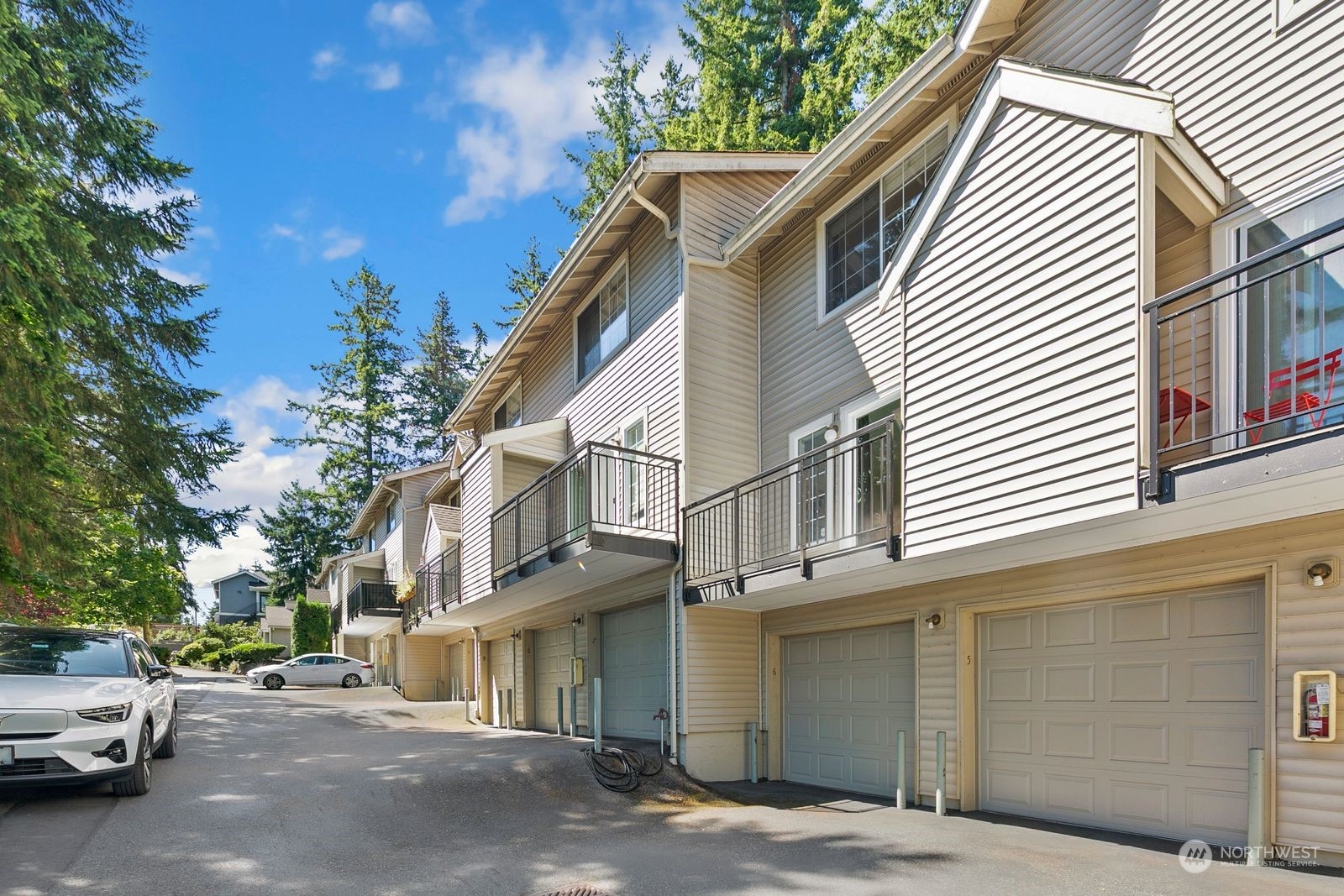 a view of a car park in front of a house