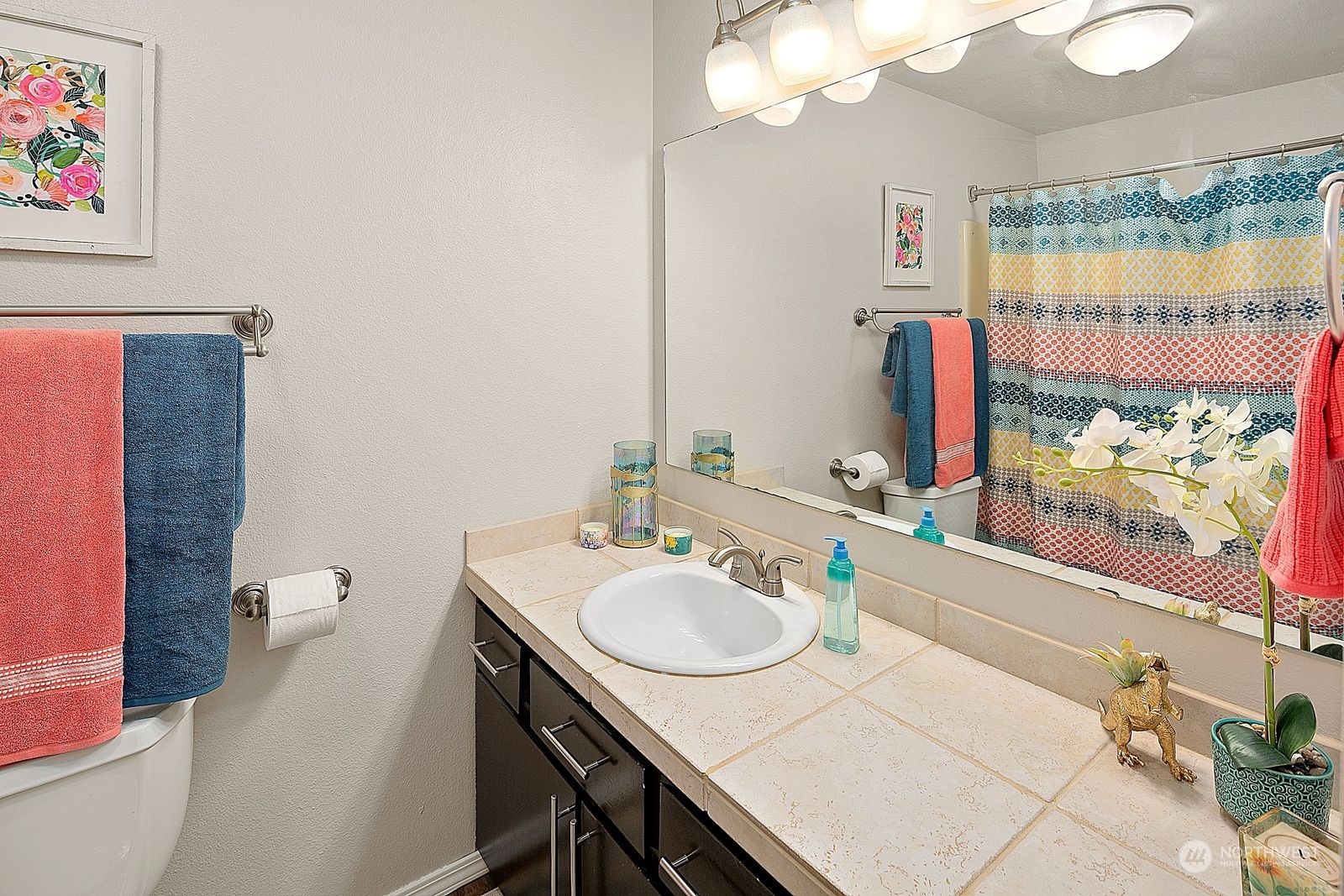 8512 242nd Street Southwest, Unit 4 Edmonds, WA 98026 - Photo 19 of 24 a bathroom with a sink vanity and a mirror