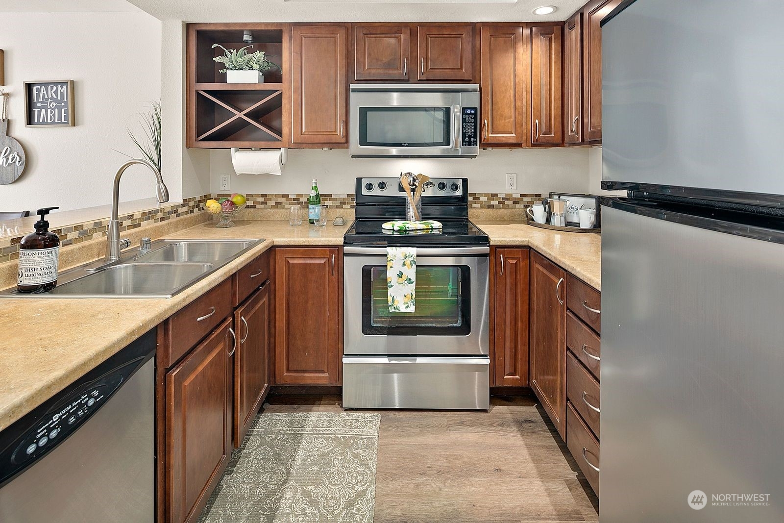 8512 242nd Street Southwest, Unit 4 Edmonds, WA 98026 - Photo 5 of 24 a kitchen with stainless steel appliances granite countertop a sink stove and microwave