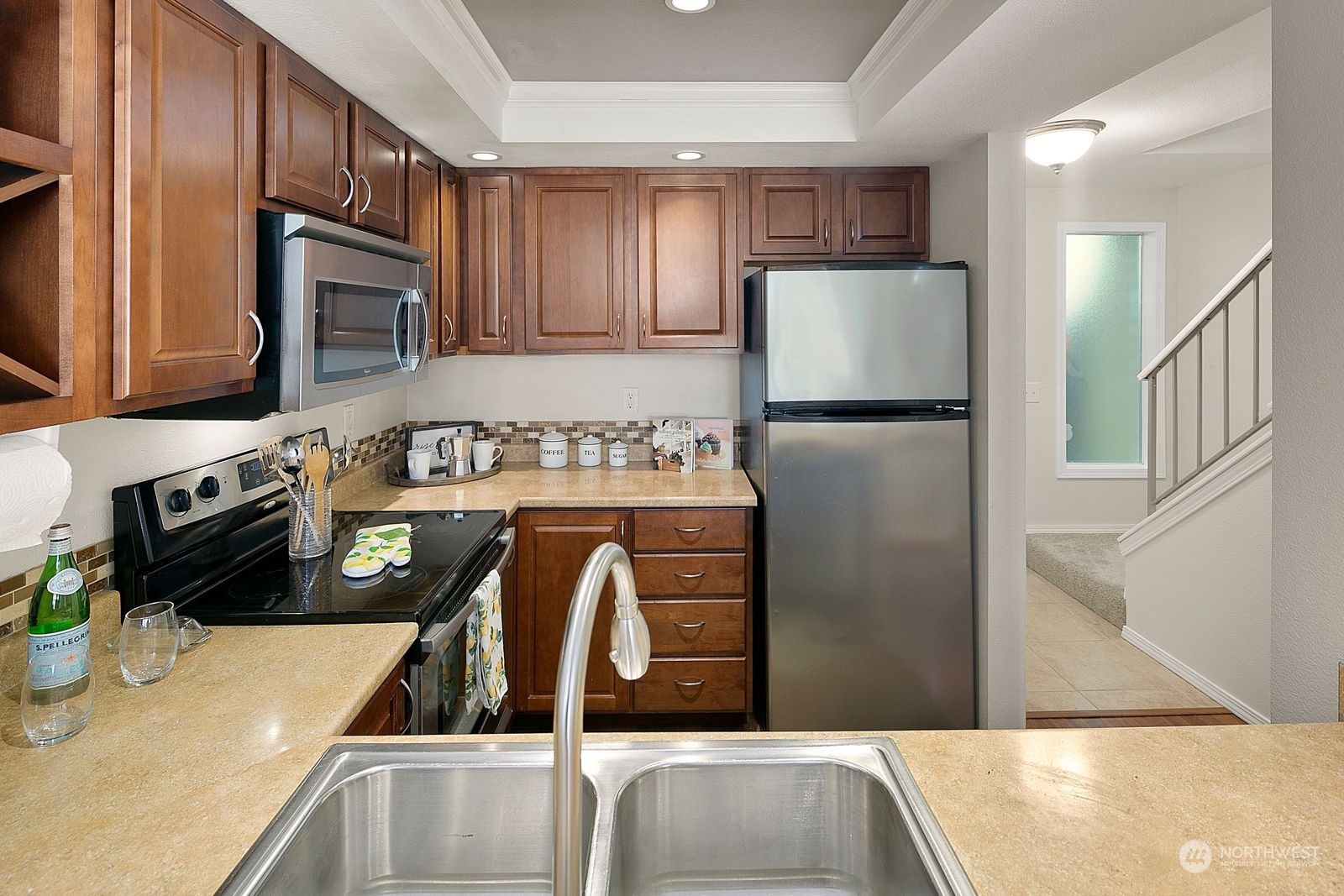 8512 242nd Street Southwest, Unit 4 Edmonds, WA 98026 - Photo 6 of 24 a kitchen with stainless steel appliances granite countertop a refrigerator a stove top oven a sink and dishwasher