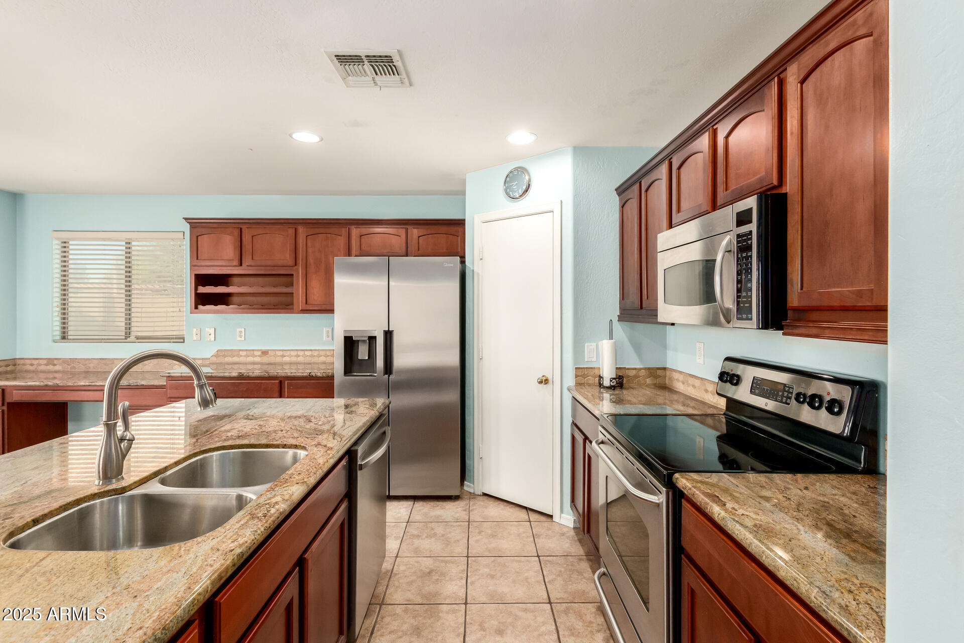 4403 West Maldonado Road Laveen, AZ 85339 - Photo 12 of 37 a kitchen with a sink stove top oven and refrigerator