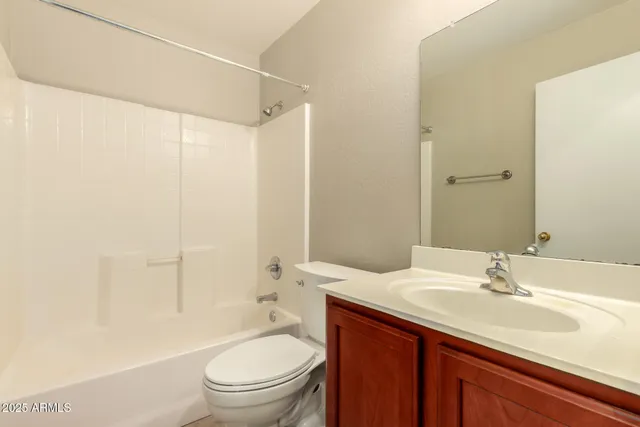 a bathroom with a sink toilet vanity and shower