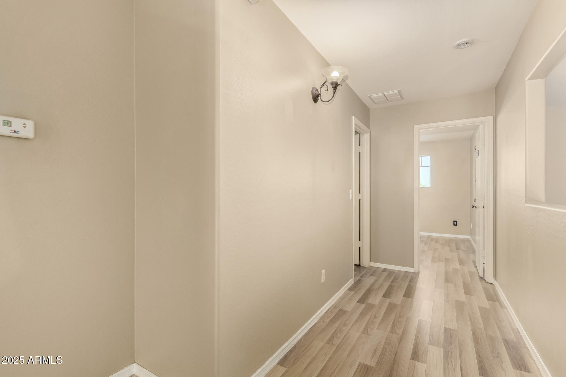 4403 West Maldonado Road Laveen, AZ 85339 - Photo 20 of 37 a view of a room with wooden floor and a bathroom