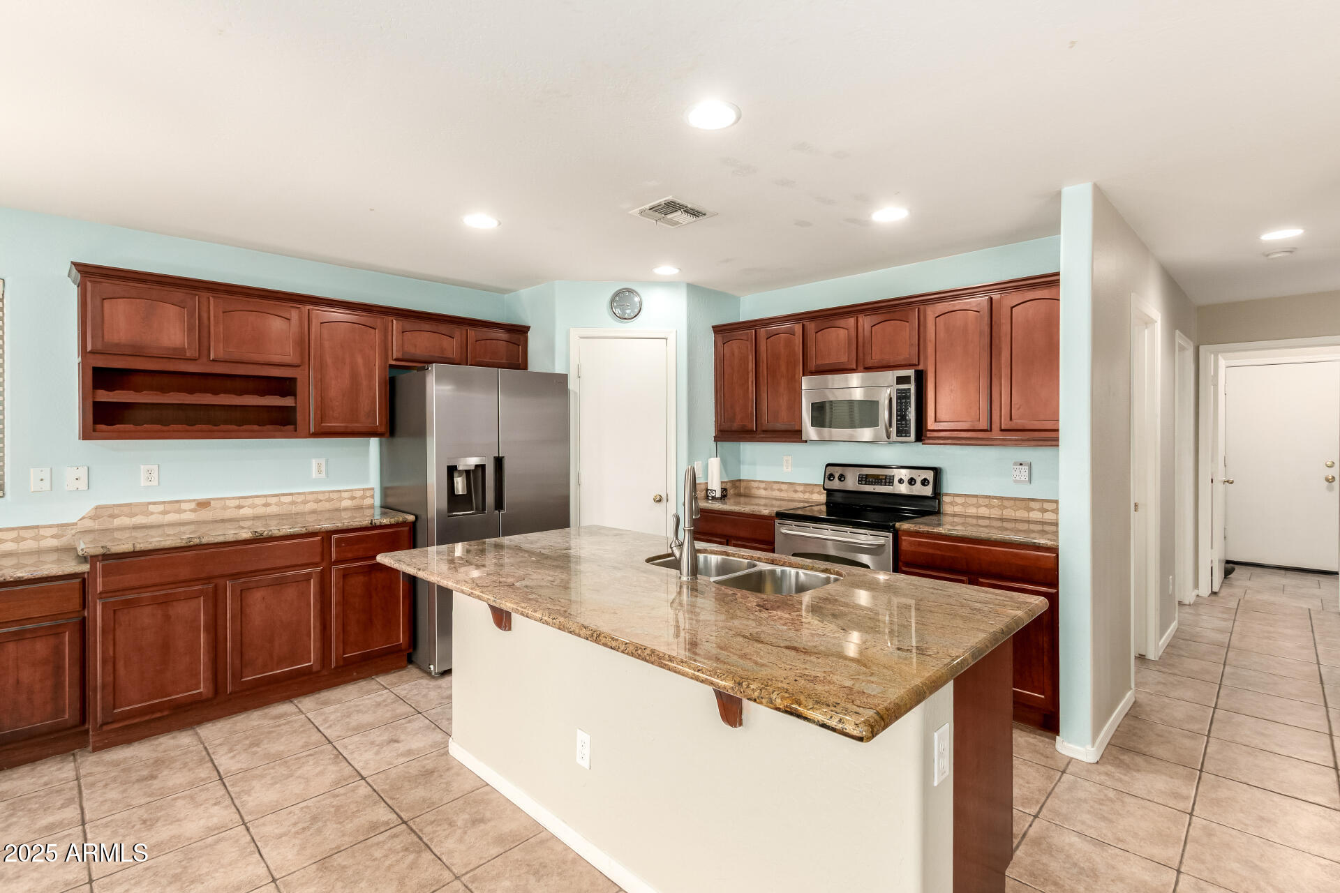 4403 West Maldonado Road Laveen, AZ 85339 - Photo 2 of 37 a kitchen with stainless steel appliances granite countertop a sink stove and refrigerator