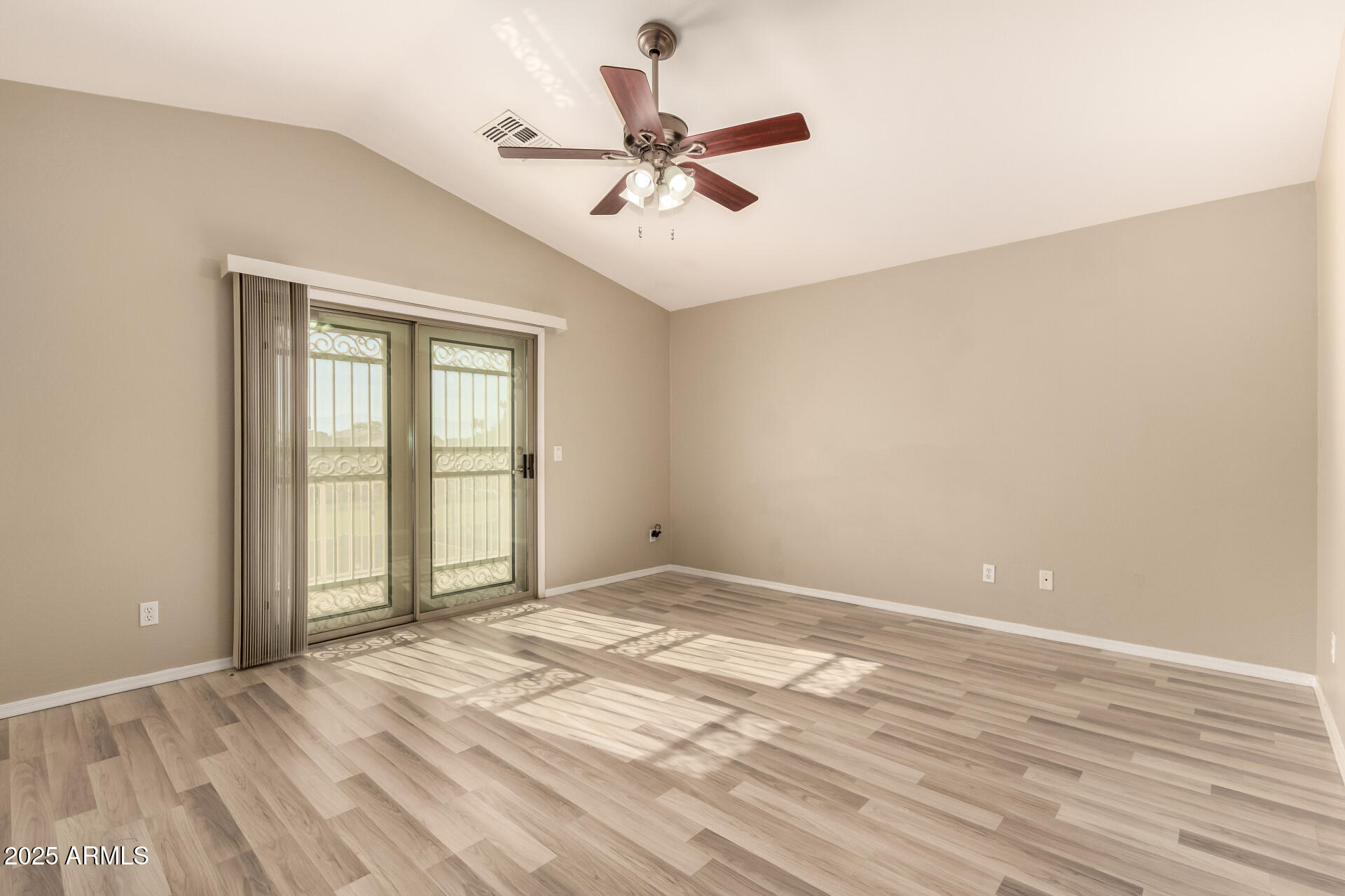 4403 West Maldonado Road Laveen, AZ 85339 - Photo 21 of 37 a view of an empty room with wooden floor and a window