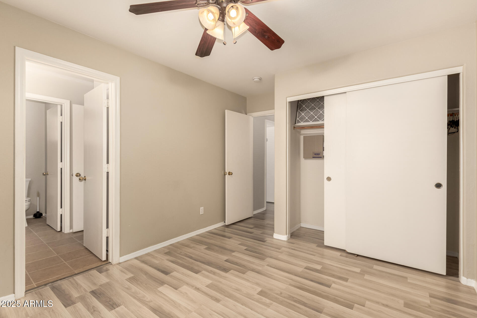 4403 West Maldonado Road Laveen, AZ 85339 - Photo 32 of 37 a view of an empty room with wooden floor